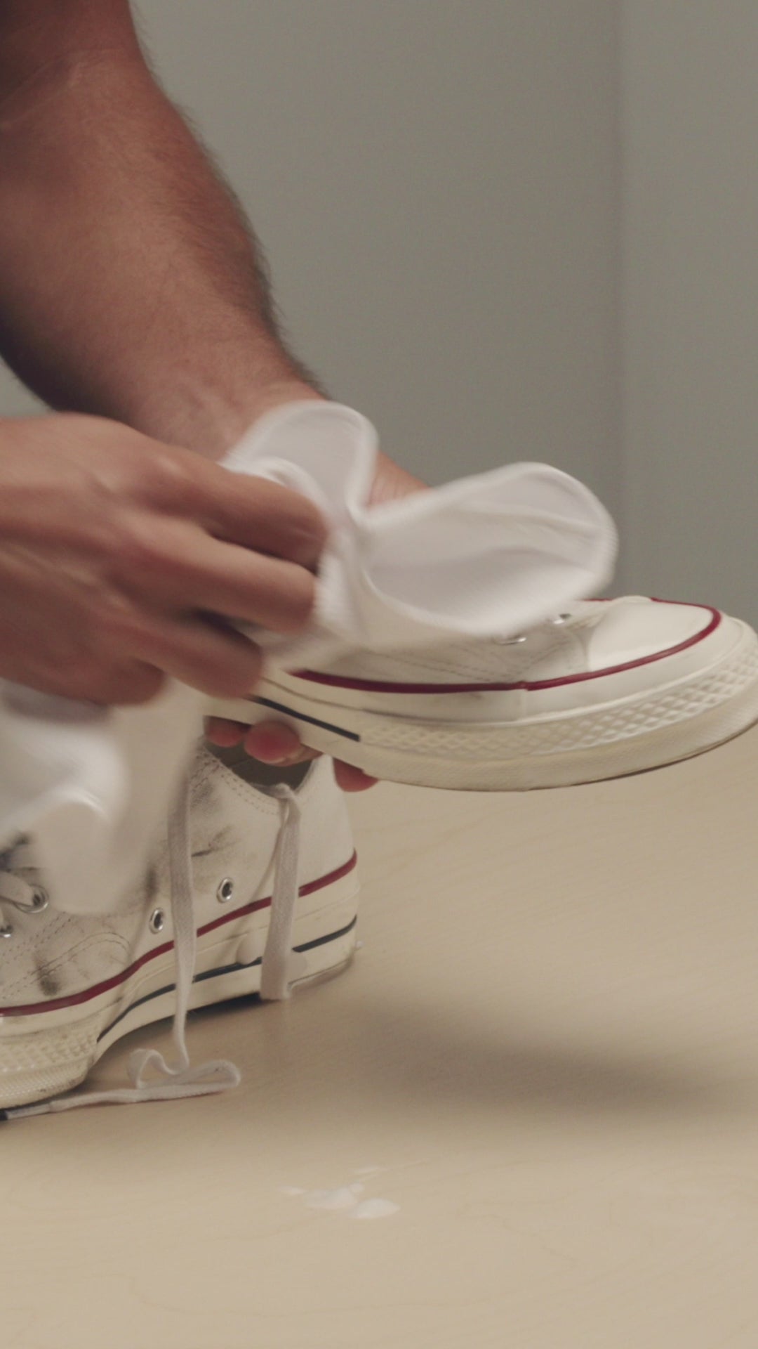 JASON MARKK MICROFIBER TOWEL WIPING A PAIR OF CONVERSE CHUCK TAYLOR LOW 1970