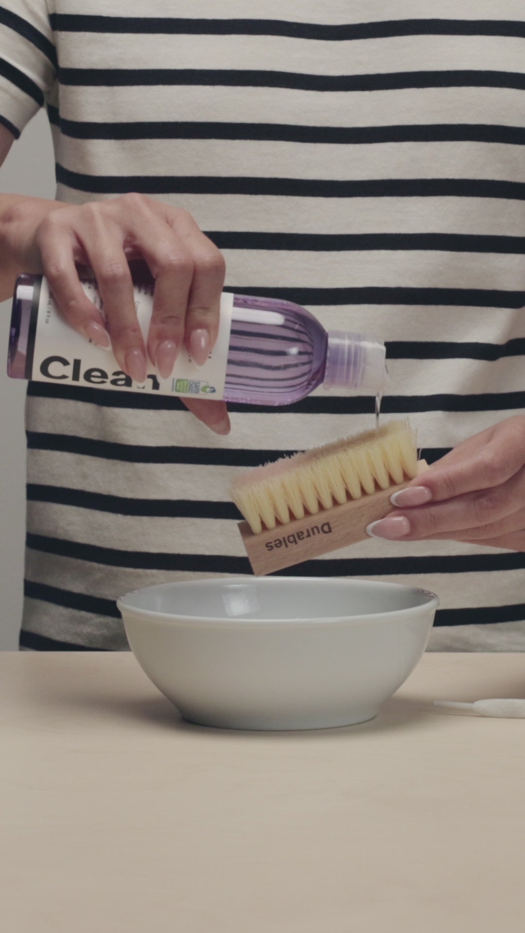 APPLYING JASON MARKK DEEP CLEANING SOLUTION ON TO A JASON MARKK DURABLES CLEANING BRUSH