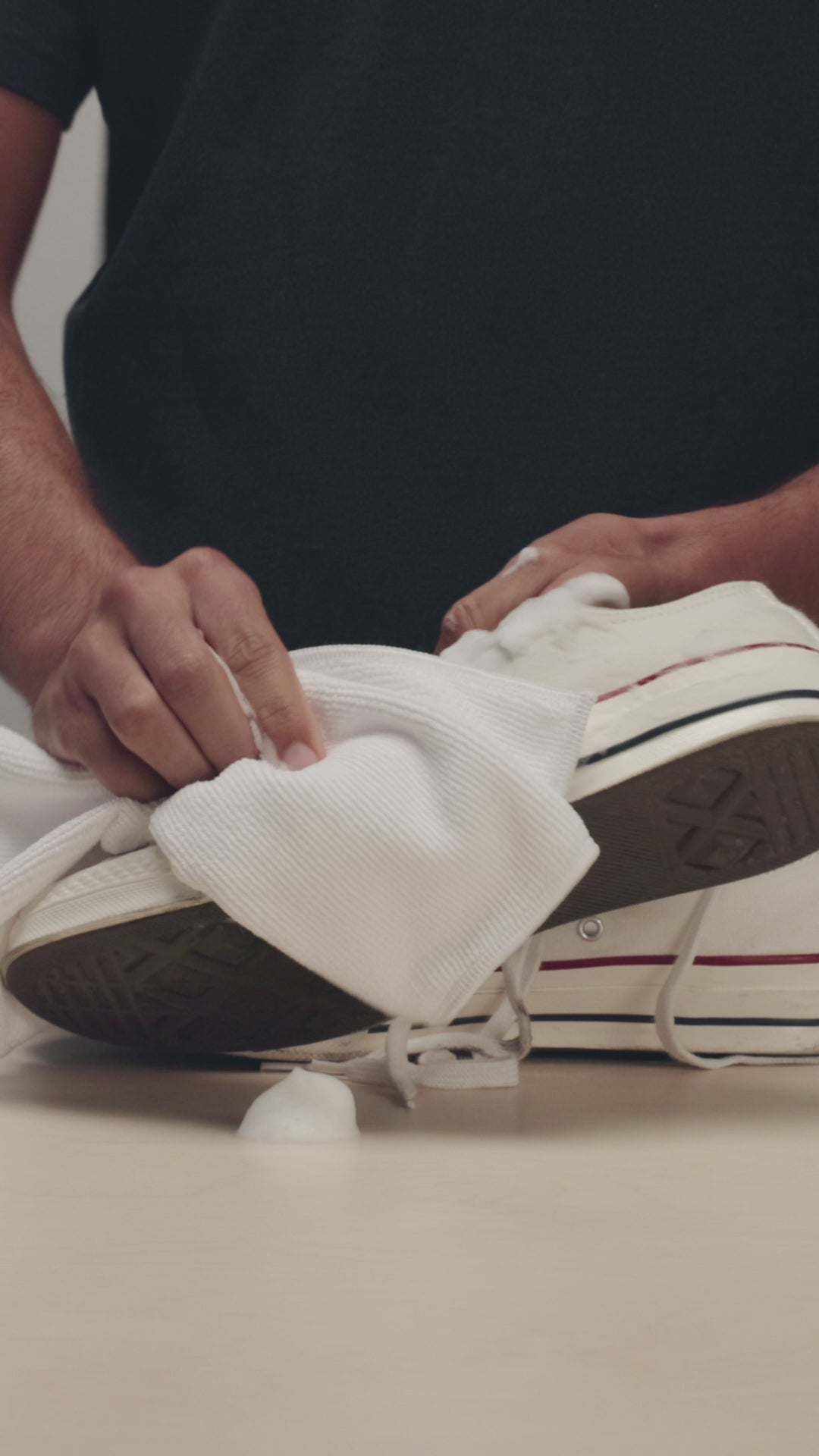 JASON MARKK MICROFIBER TOWEL WIPING A PAIR OF CONVERSE CHUCK TAYLOR LOW 1970