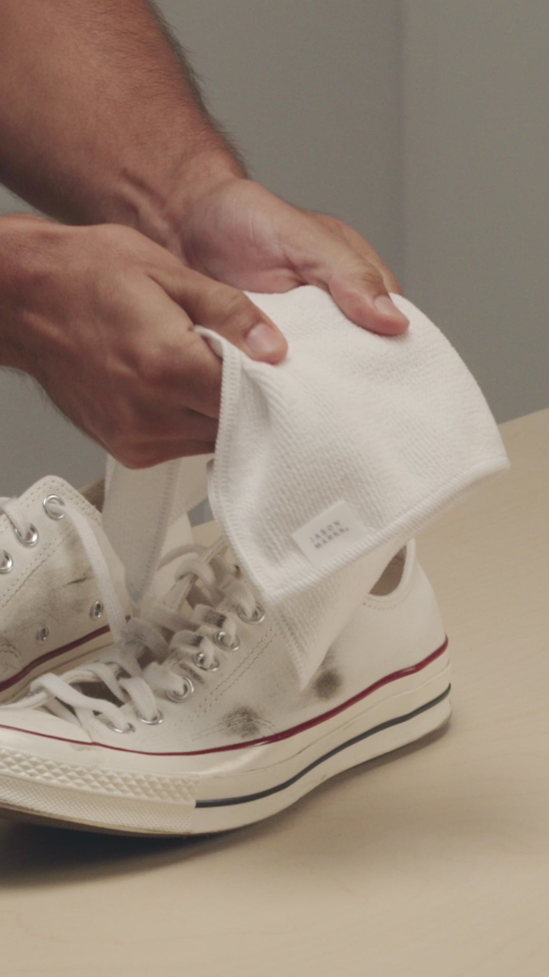 JASON MARKK MICROFIBER TOWEL SHOWN IN HAND TO SHOWCASE TEXTURE AND DURABILITY