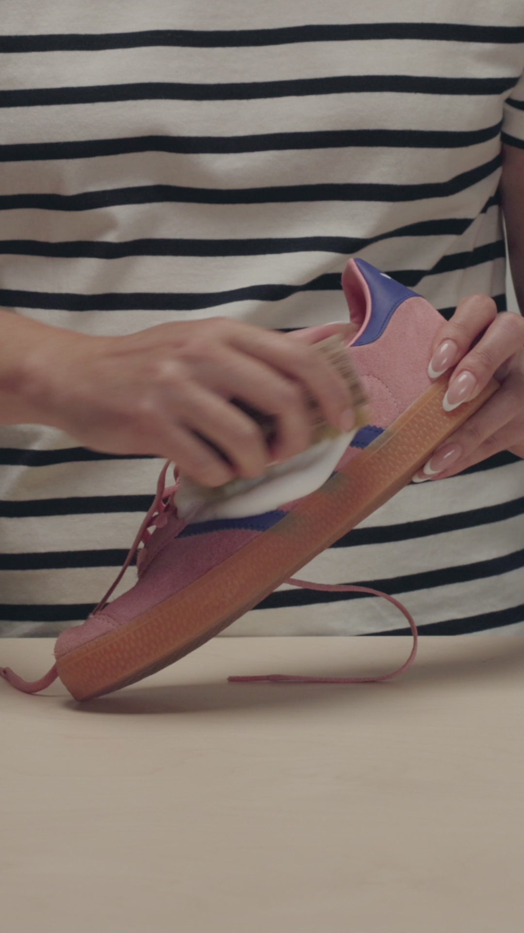 SCRUBBING A PAIR OF PINK ADIDAS GAZELLE SHOES WITH A JASON MARKK DELICATES CLEANING BRUSH AND FOAM CLEANER