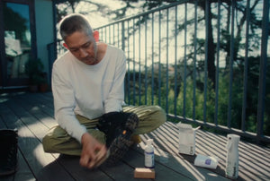 Founder of Jason Markk cleaning hiking boots on a deck outdoors